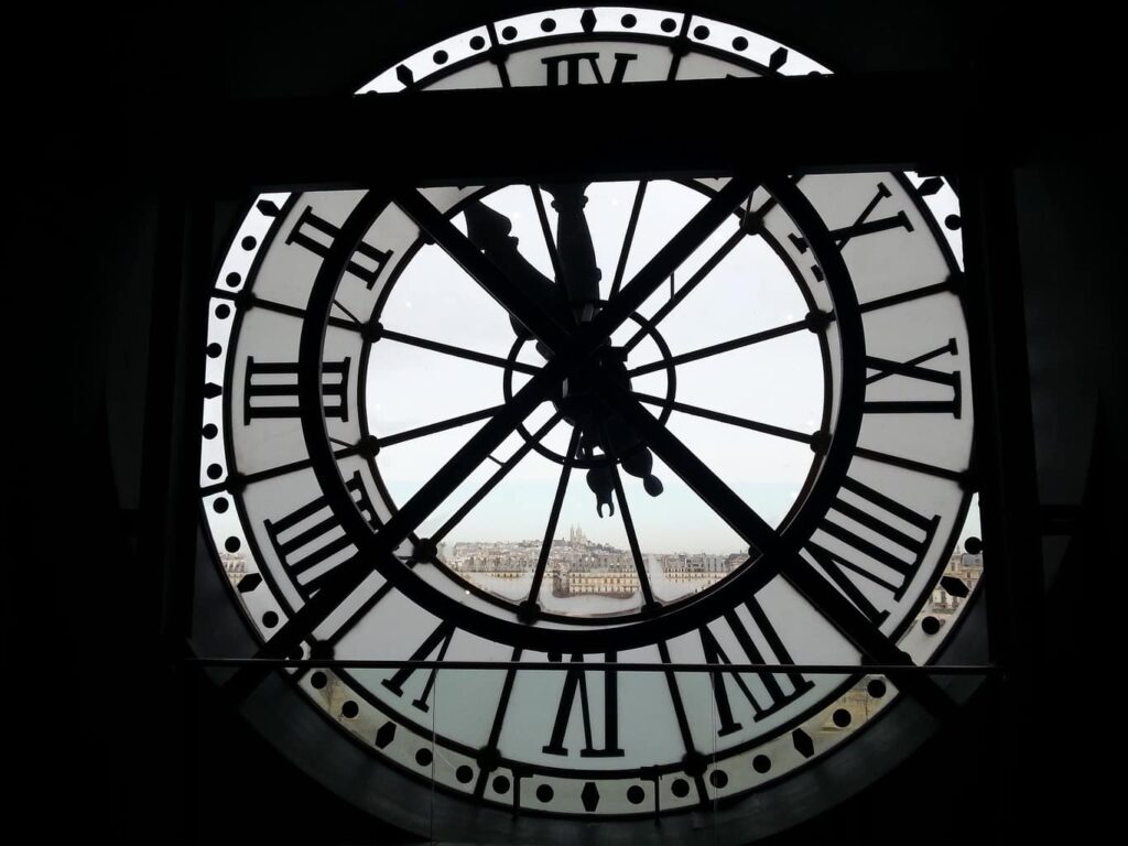 View of the clock inside the D'Orsay Museum as you look out onto the Tuileries Garden. 