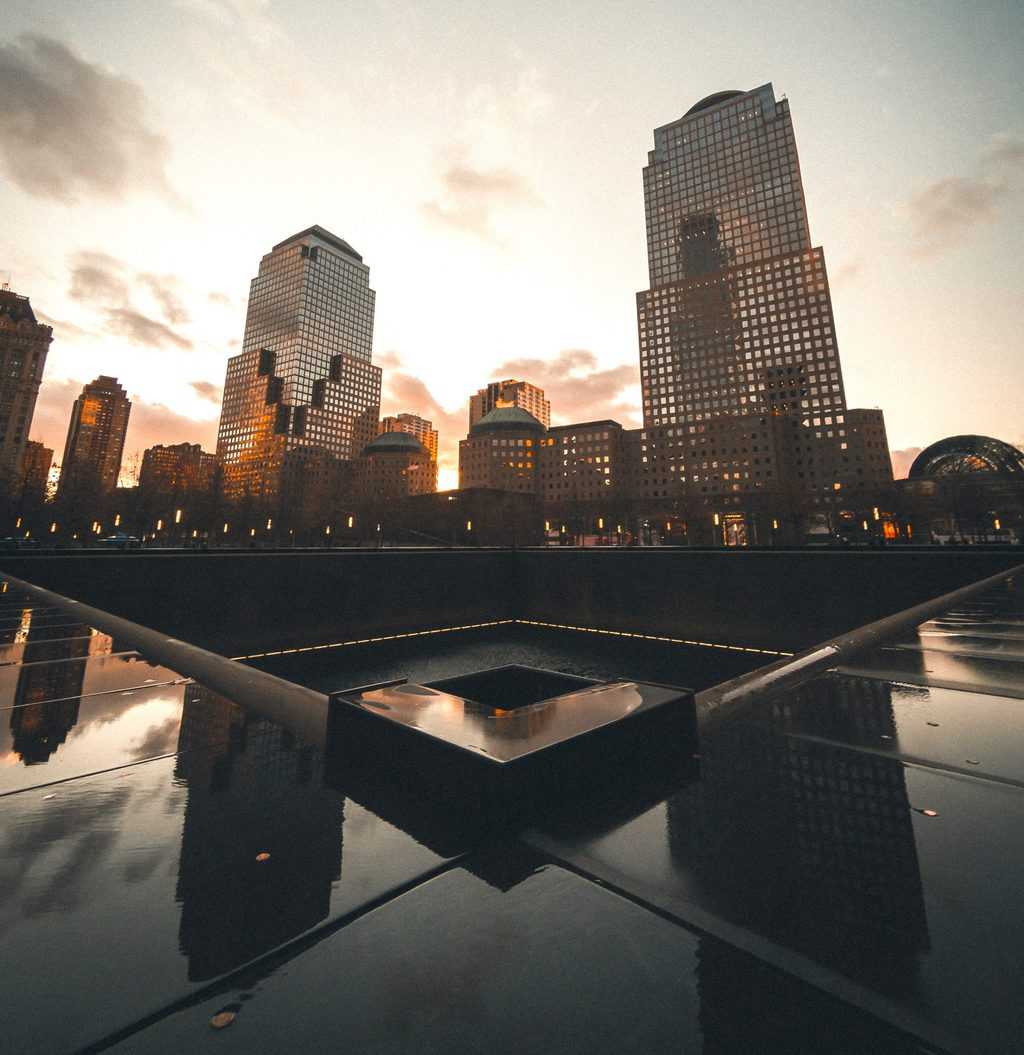 The poignant, 9/11 Memorial sits where the twin towers once stood. It is a square pool made of black stone that has the names of all the vicitims engraved in it. 