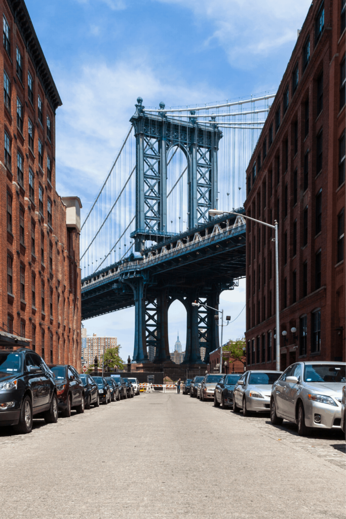 DUMBO and the Manhattan bridge surrounded by brick warehouses.