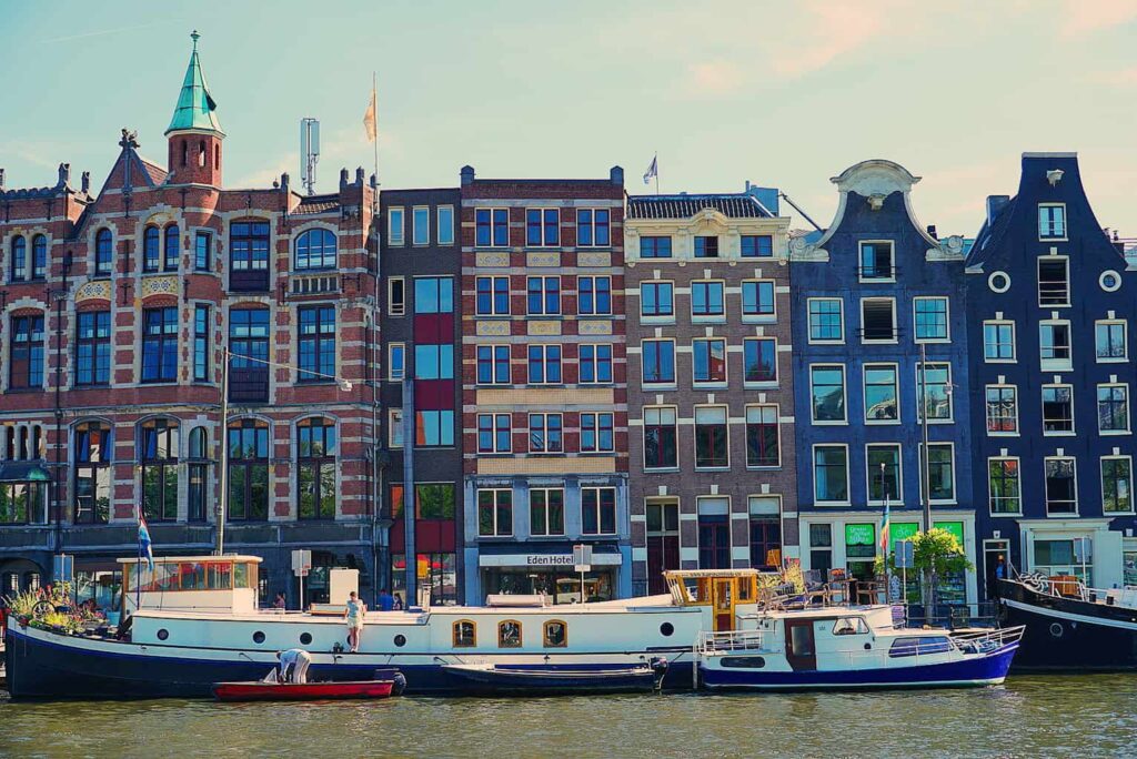 View of the canal homes and boats that line the canals of Amsterdam. Enjoy this and more during the best foodie tour Amsterdam has to offer. 