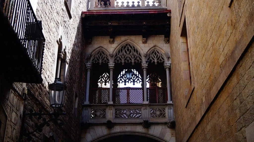 Is Barcelona safe for solo female travelers? It is as long as you stick to safe neighborhoods like the Gothic Quarter which is pictured here with a historic, covered arway. 
