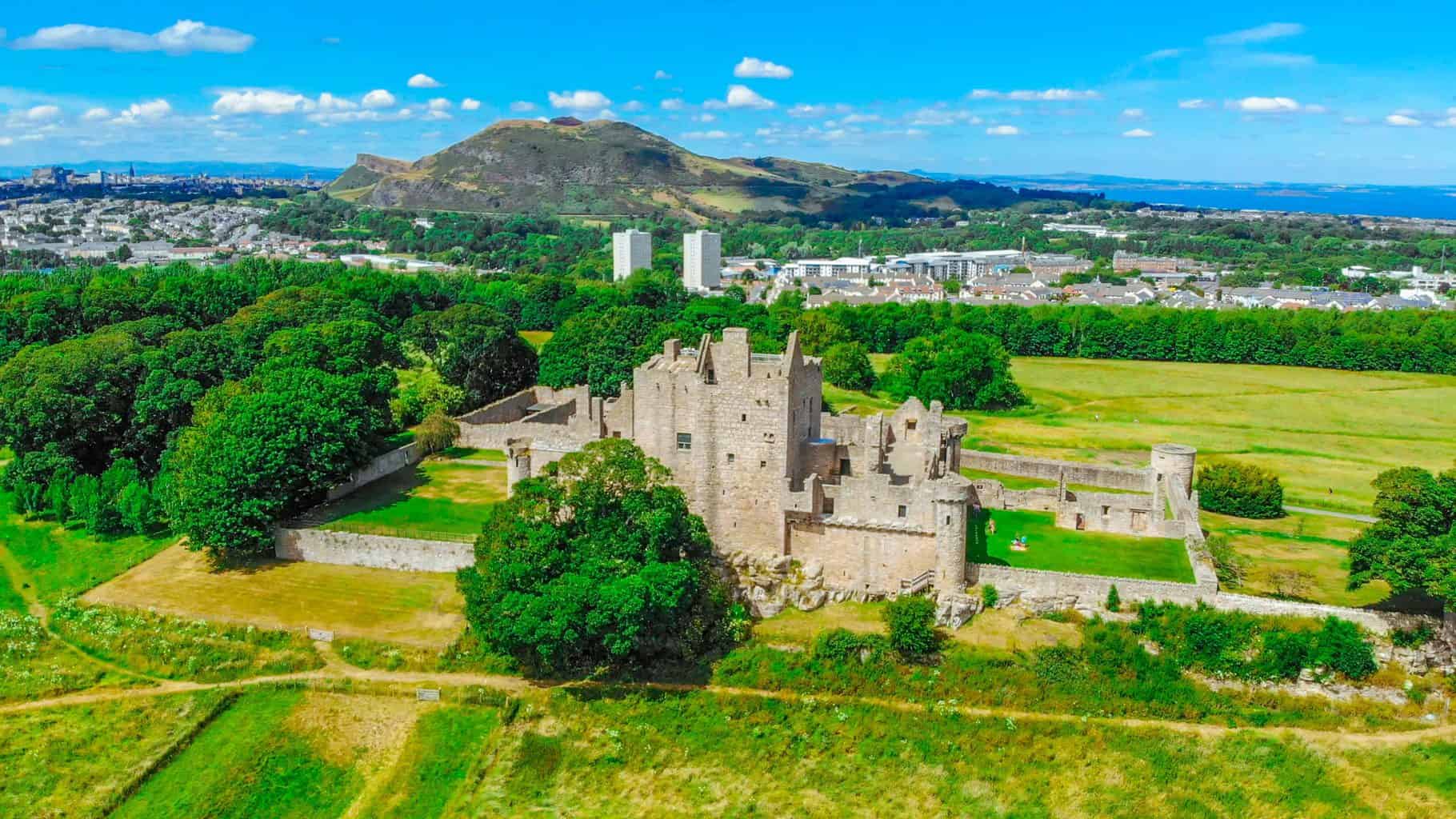 An aerial view of the ruins at Craigmillar Castle and the city of Edinburgh.