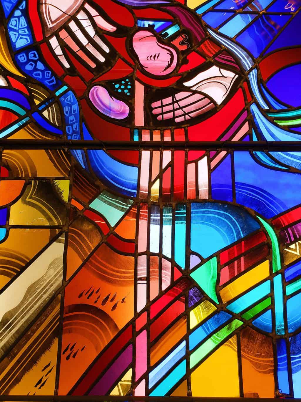 A vibrant stained glass window of kidneys and surgical hands at the Surgeon's Hall Museum, one of the most unusual things to do in Edinburgh. 