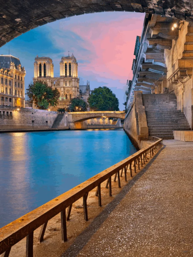 View of Notre Dame and Paris at sunset along the Seine. 