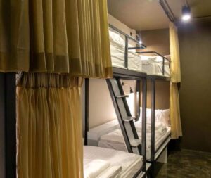 The simple, but clean and private dorm beds that you'll find at The Spades Hostel in Bangkok.
