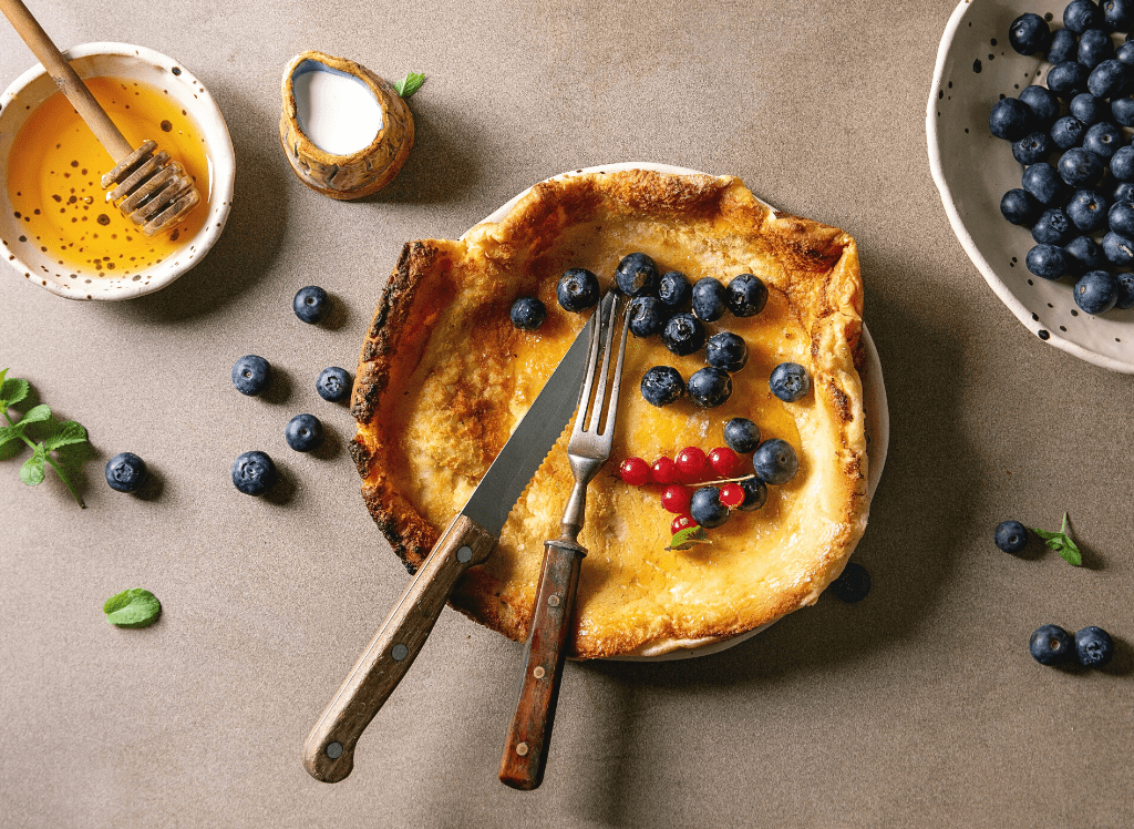 Aerial view of a Dutch pancakes with blueberries and raspberries. 