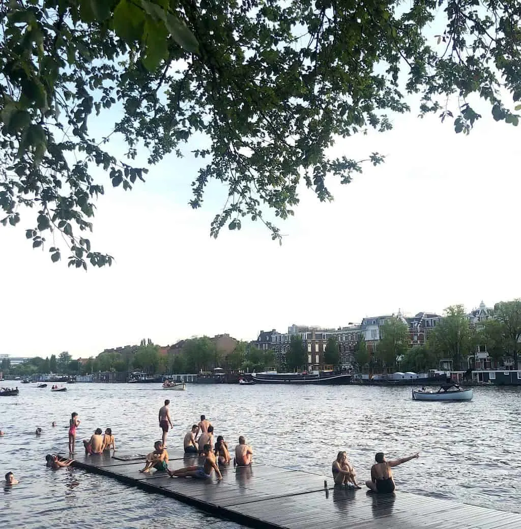 Excited swimmers enjoying the Amstel River, one of the many Amsterdam hidden gems out there.