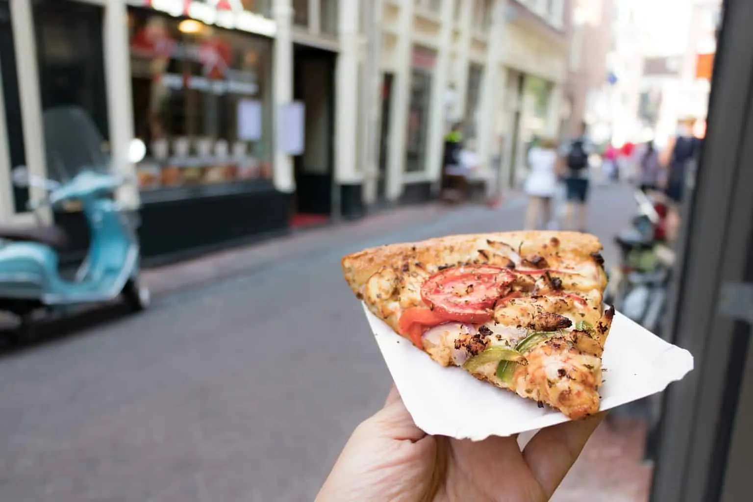 Enjoy a slice of pizza at Amsterdam's San Marco Pizzeria, home to the only boat-through in the world. 