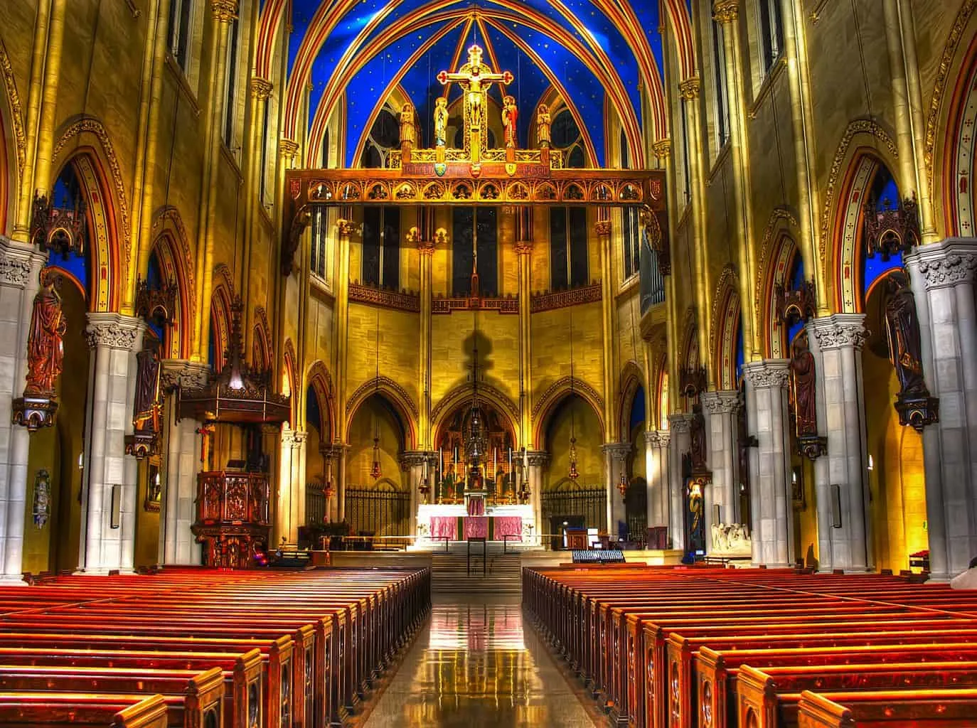 The expansive, blue, and gold interior of St. Mary the Virgin Church near Times Square, New York City (image sourced from Flickr.com). 