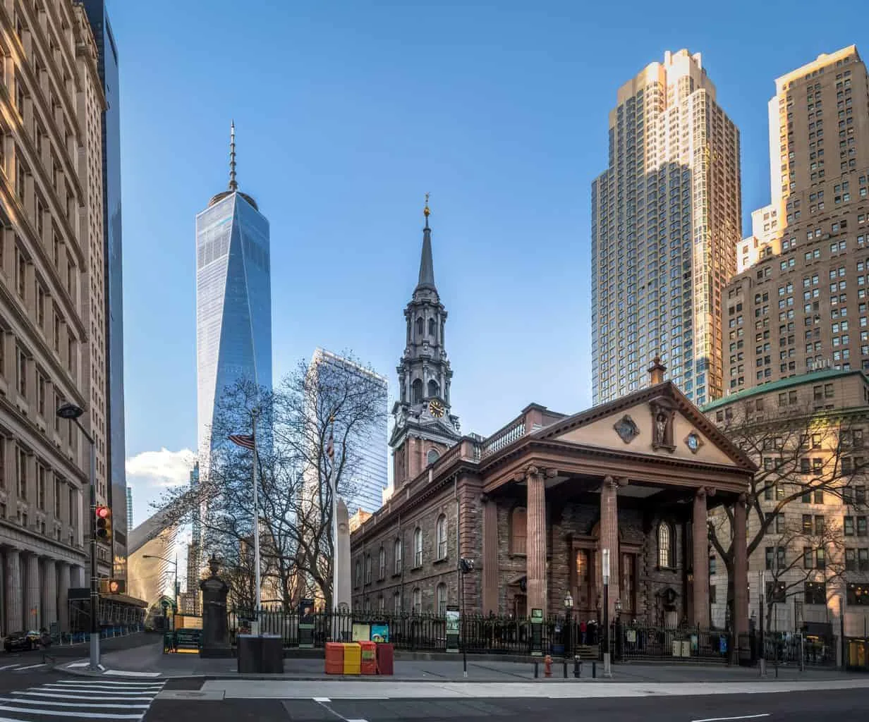 St. Paul's Cathedral quietly sits in Lower Manhattan with One World Trade Center standing tall in the background. 