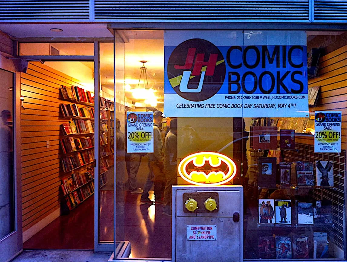 The low-key, blue-hued exterior of JHU Comic Books in Staten Island, New York. 