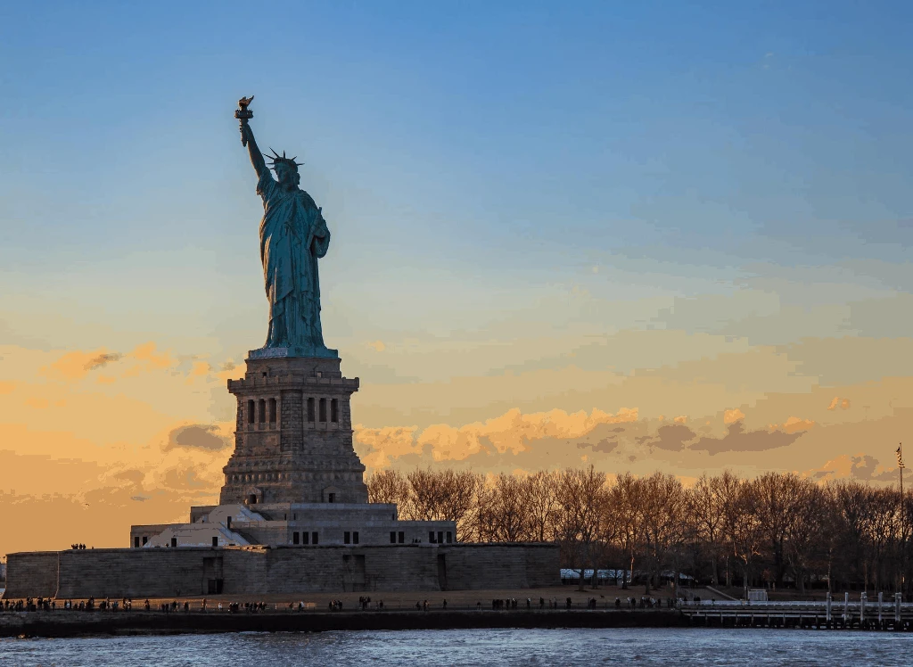 During your cruise, enjoy a beautiful view of the statue of liberty at sunset. 