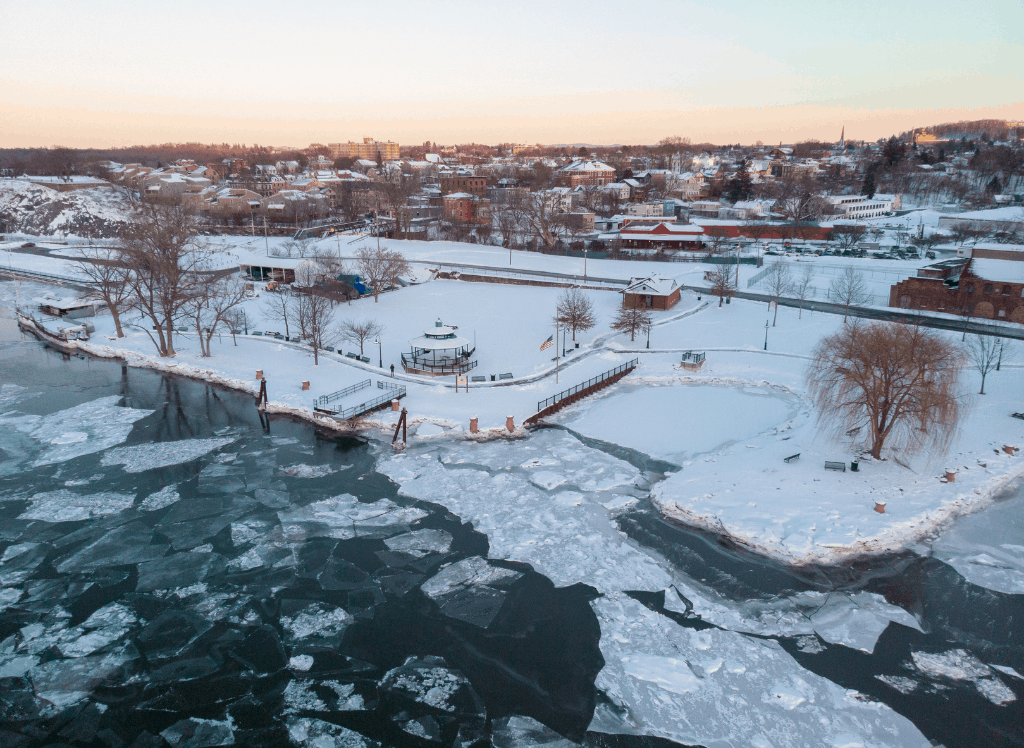 An aerial view of Hudson NY covered in snow in the winter.