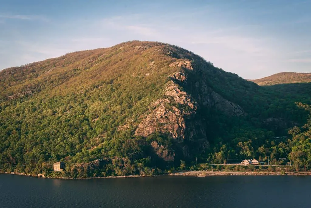 View of Breakneck Ridge at sunset from Storm King Mountain. You can see the river at the base of the mountain. 