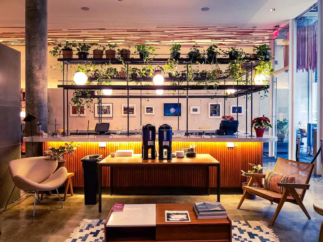 The modern, ground-floor coffee and lounge area of the Selina Chelsea Hotel.