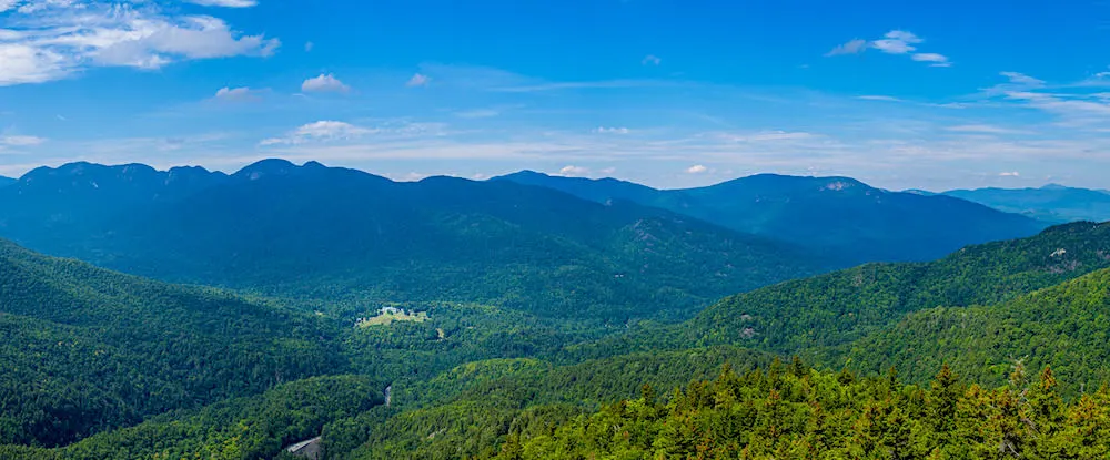 The panoramic view of the green trees at Allen Mountain from Giant Mountain which can be seen when you head on one of the best hikes in the Adirondacks.