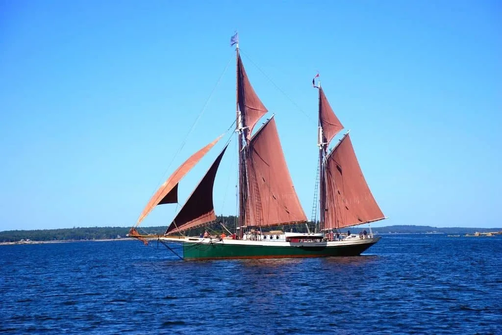 A Maine windjammer with red sails.