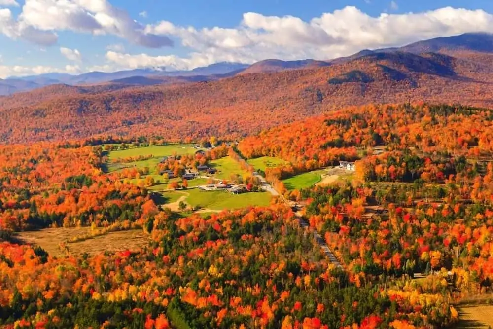 An aerial view of foliage around Stowe Vermont in the fall. 