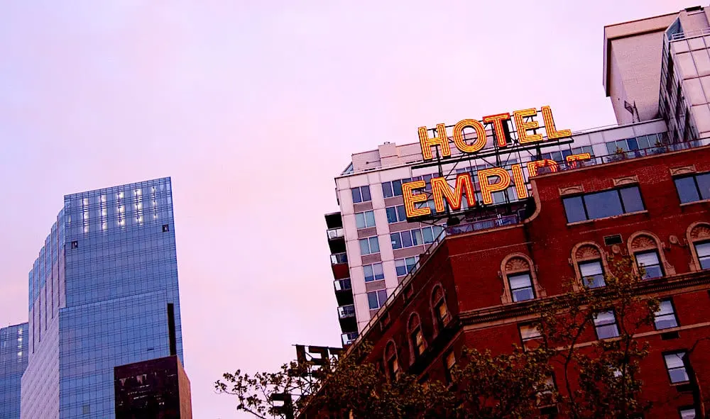 View of the sign and rooftop of the Empire Hotel in NYC.