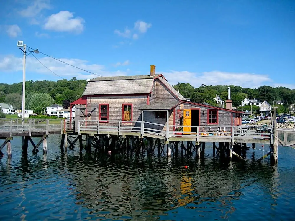 One of the best things to do in Boothbay Harbor Maine is to walk along this footbridge and since this historic house.