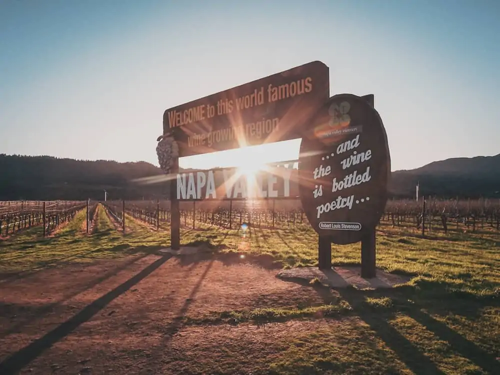 Sun shining through the welcome sign to Napa Valley California