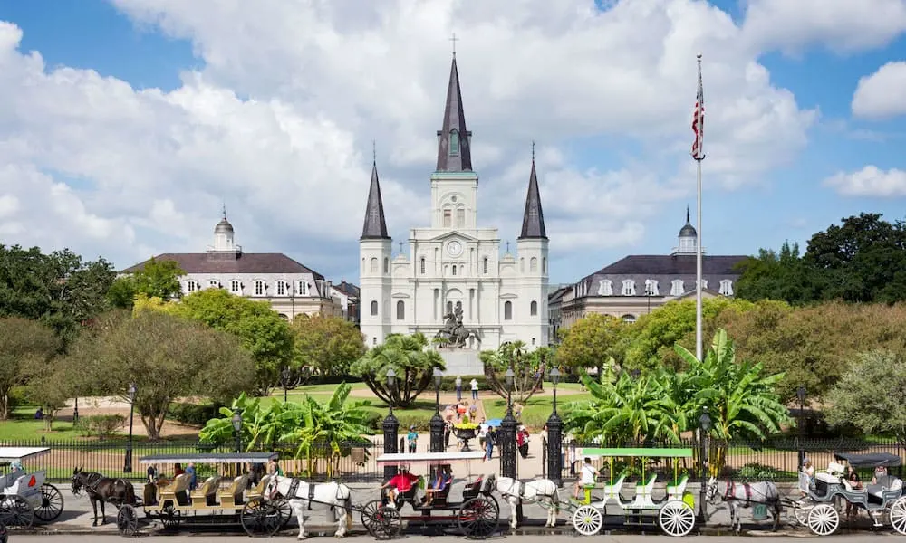 Horse drawn carriages siting along Jackson Square in New Orleans, Louisiana. 