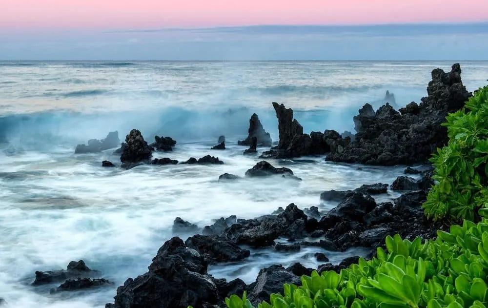Waves crashing on the coast of Kona Hawaii at Twilight. The warmest place in US in December. 