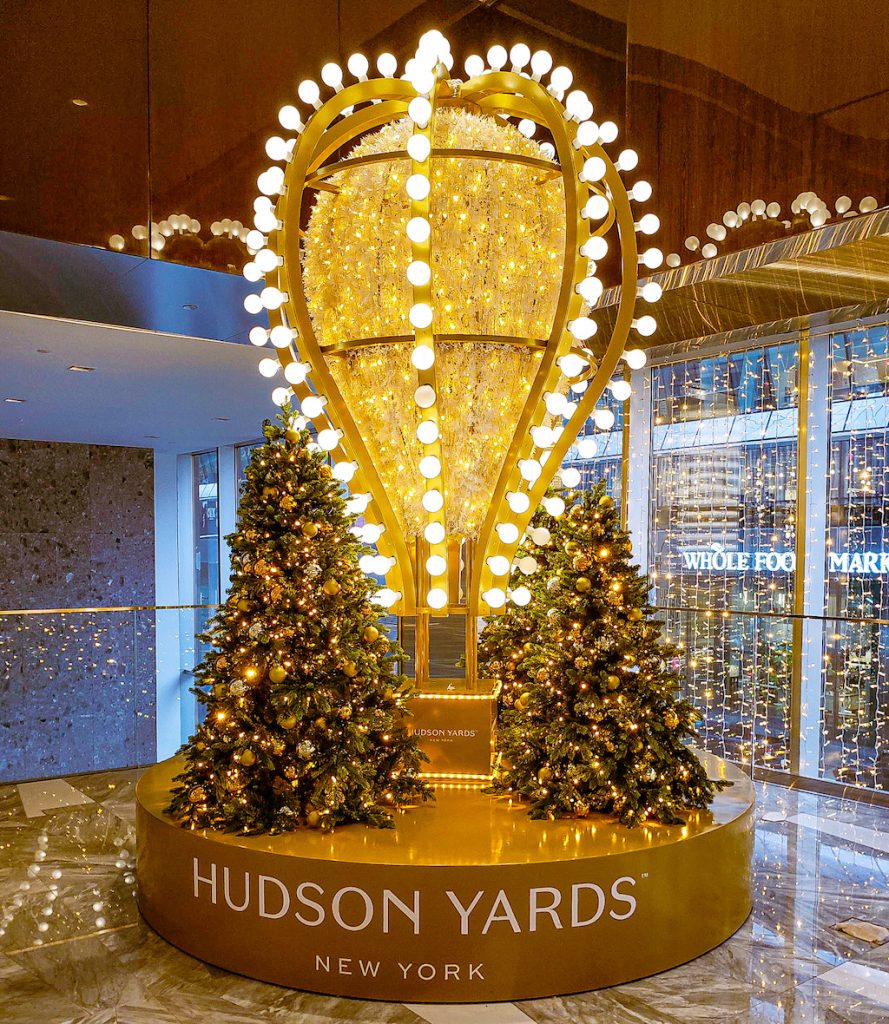 Golden hot air ballon and the NYC Christmas lights at Hudson Yards. 