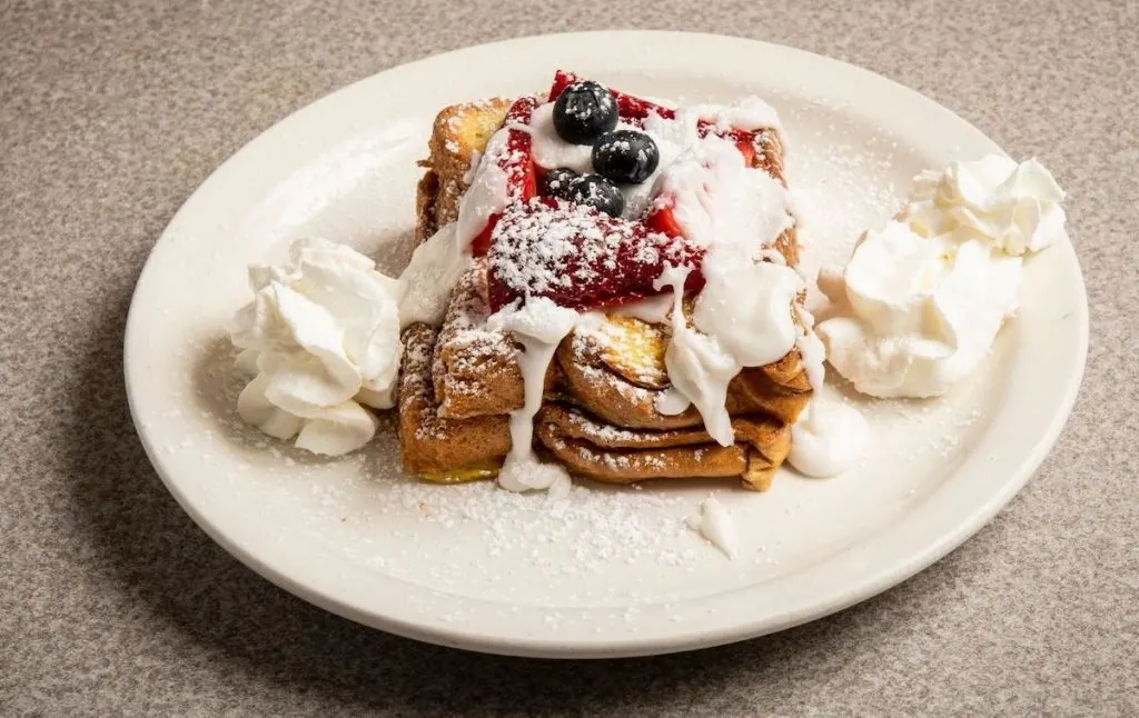 French toast with whipped cream and berries. 
