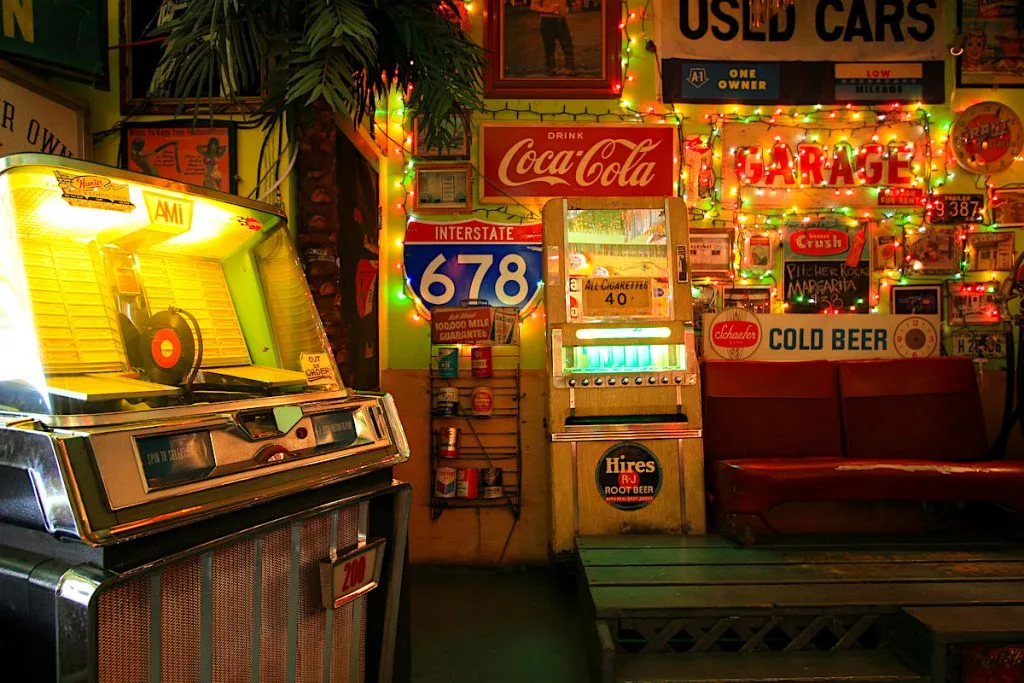 Fun and funky interior of trailer Park Lounge with a juke box, Christmas Lights, and a highway sign. 