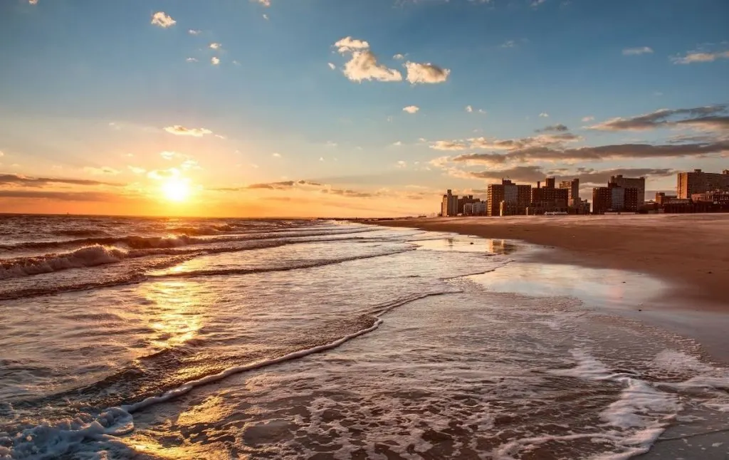 View of the sun setting on Brighton Beach in Brooklyn, one of the top beaches in Brooklyn. 