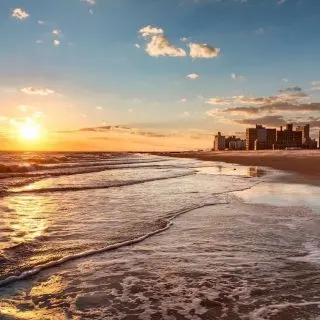 View of the sun setting on Brighton Beach in Brooklyn, one of the top beaches in Brooklyn.
