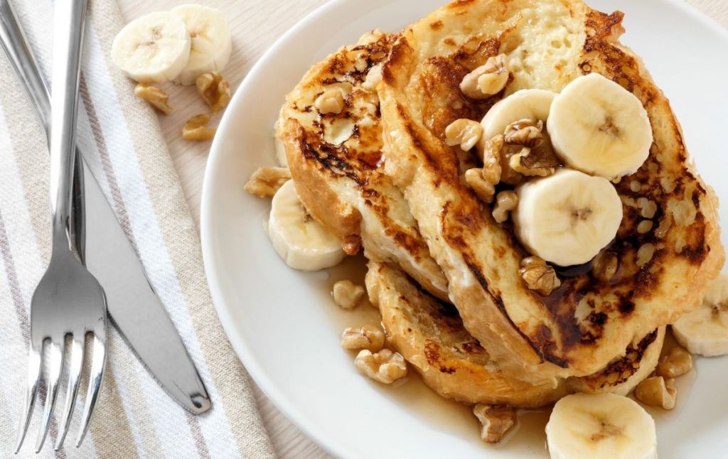 French toast with bananas and walnuts on top at the best roof top brunch NYC has to offer. 
