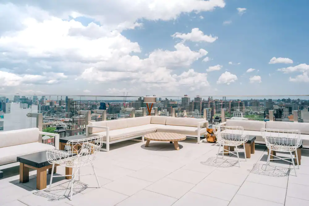 Bright and airy rooftop of The Crown in Hotel 50 Bowery. One of the best rooftop restaurants in New York City. 