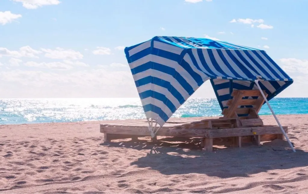 Blue and white striped private beach cabana at one of the best beaches in Brooklyn. 