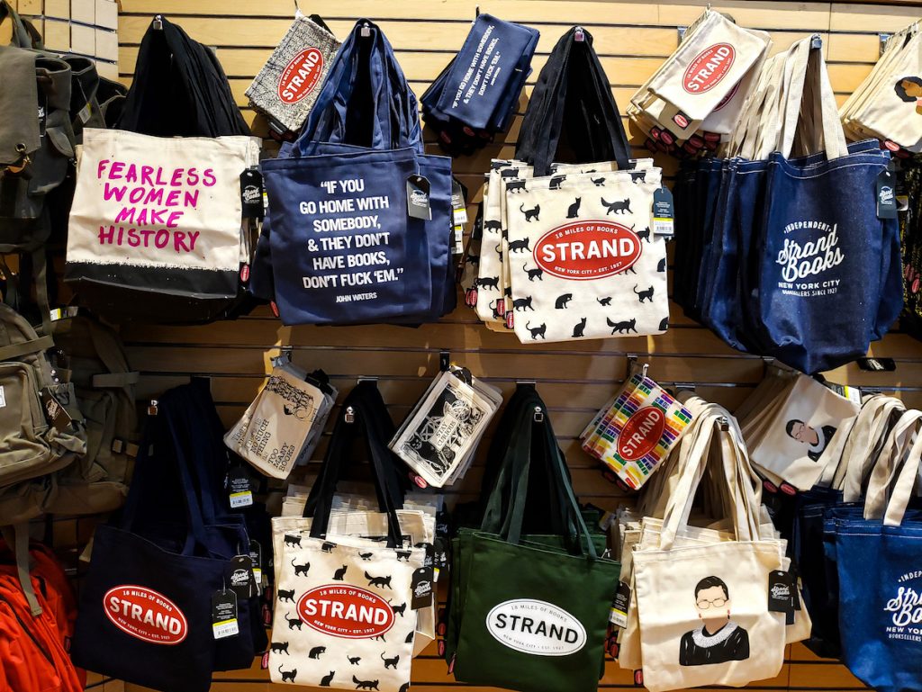 Tote bags on a wall at Strand bookstore and home to some of the best souvenirs in New York. 