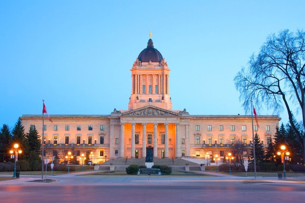 View of the Manitoba Legislative Building  with its lights on in Winnipeg which is one of the best provinces to live in Canada.