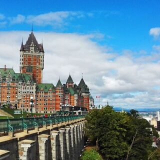 View of historic brick buildings of the Château Frontenac in Quebec city with a green roof. There are also stunning views of the area. But one of the cons of living in Canada is that most people here speak French.