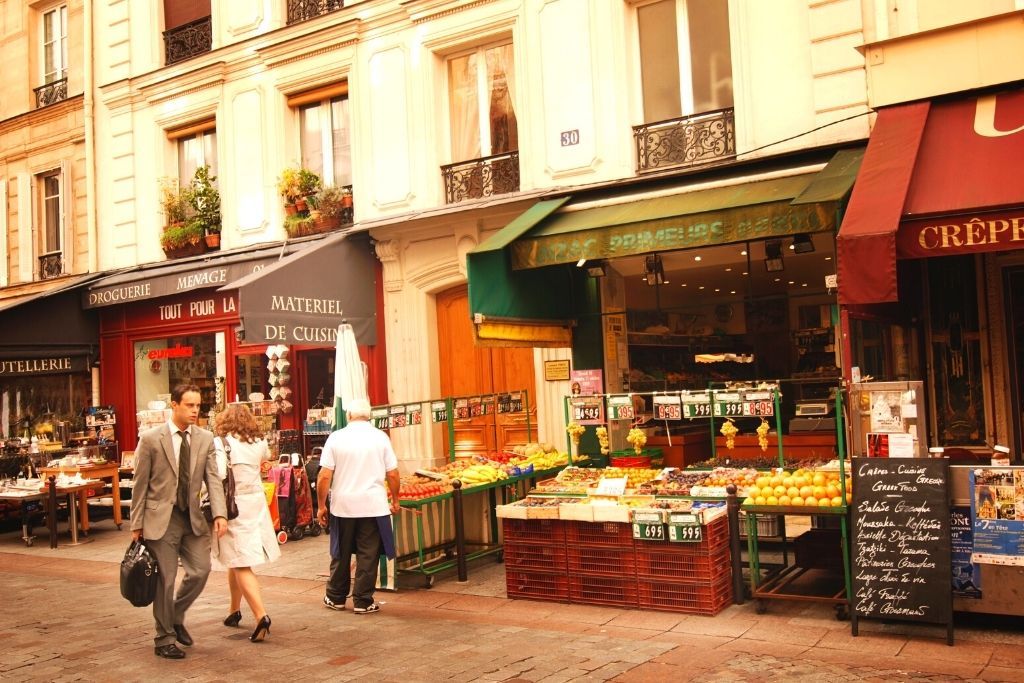 Shoppers walk down Rue Cler and pass the many markets on one of the best streets in Paris. 