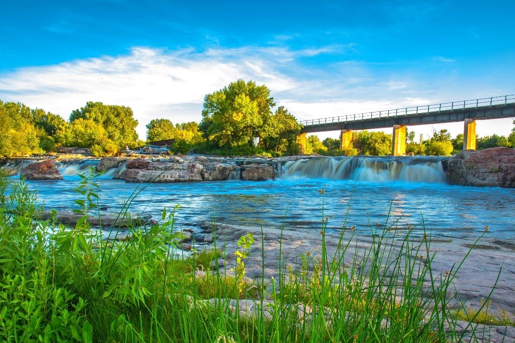 Majestic waterfalls you'll find in downtown Sioux Falls, one of the best stops on your New York to Los Angeles road trip. 