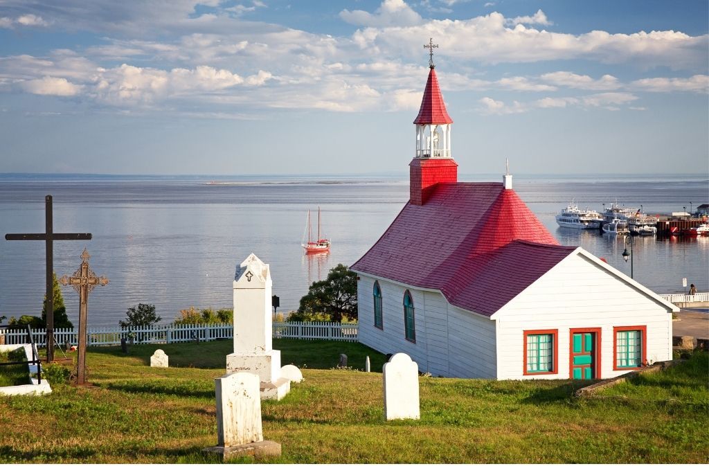 Small church overlooking the water in Tadoussac during your Road trip through Quebec. 