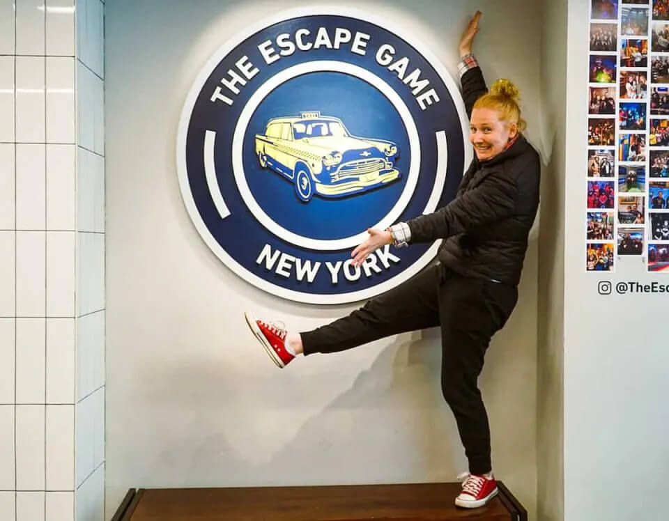 Posing at the logo of The Escape Game