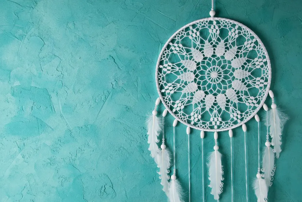 Canadian dream catcher on a turquoise background that makes for one of the best souvenirs from Canada. 