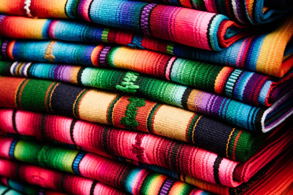 A pile of colorful blankets make for some of the best Mexico souvenirs of all time.  