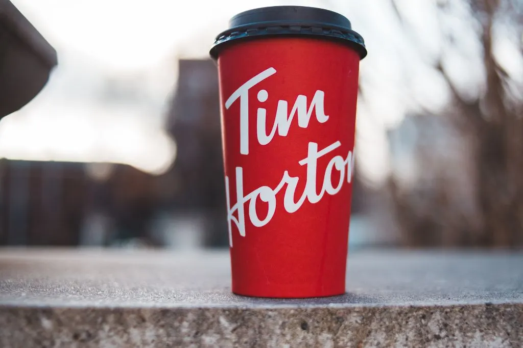 Red cup with the Tim Horton's logo on it and a black top. 