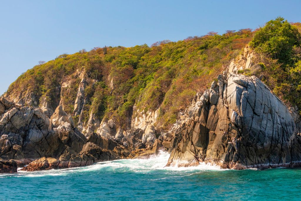 View of the rugged coast of Cacaluta Bat which is homw to one of the best beaches in Oaxaca. 