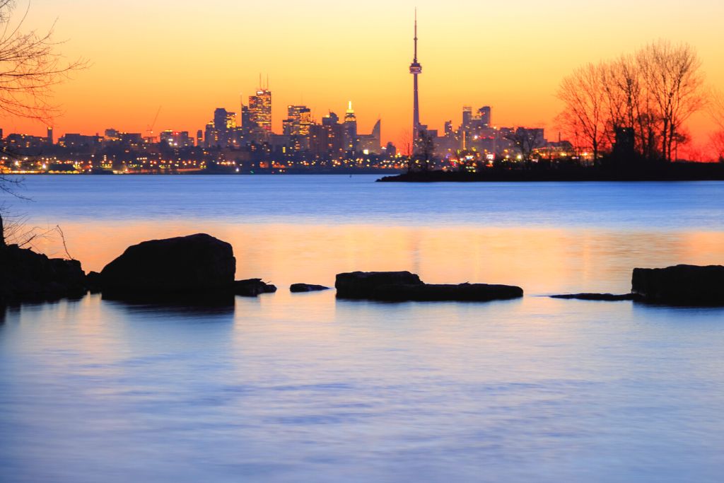 View of the sunrise over the Toronto skyline from Humber Bay Park. 