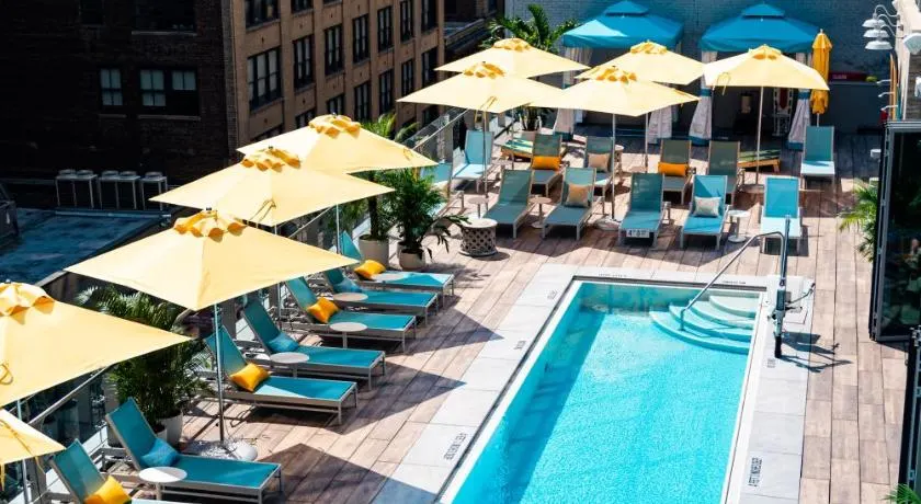 Rooftop pool and lounge chairs with umbrellas at the Margaritaville Resort Times Square. 