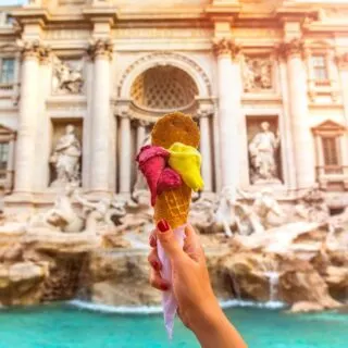 Holding gelato in front of the Trevi Fountain in Rome.