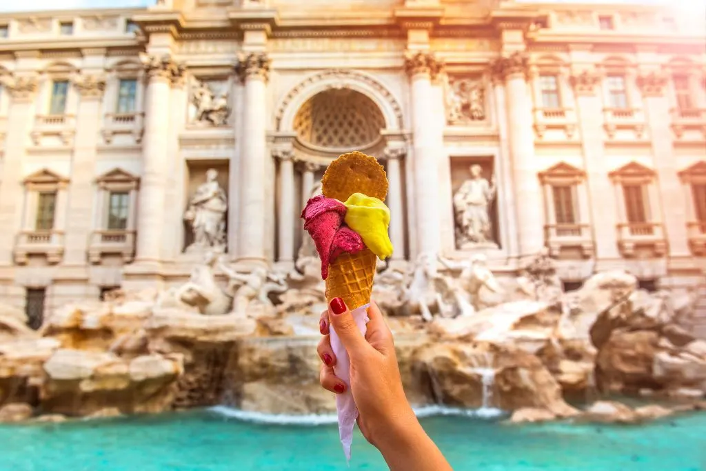 Holding gelato in front of the Trevi Fountain in Rome.
